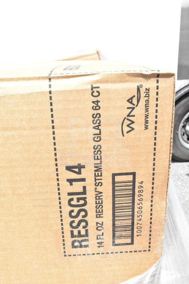 Box labeled "WNA 14 FL OZ RESERY STEMLESS GLASS 64 CT," part of 22 new scratch and dent auction items.