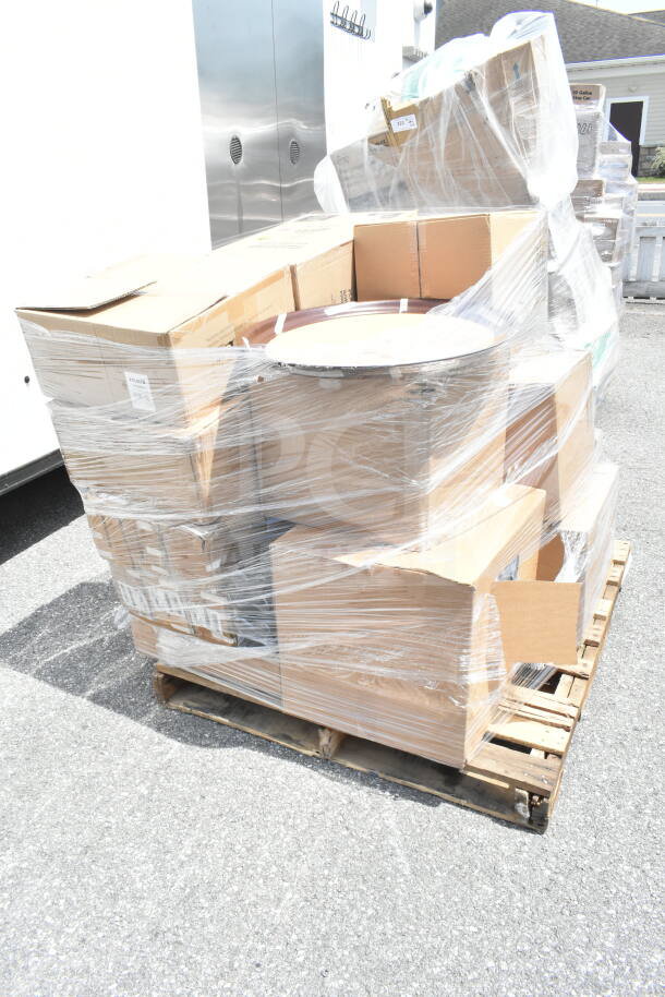 Pallet with 22 scratch and dent items including a paddle and serving tray, wrapped in plastic, multiple boxes visible.
