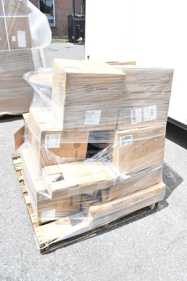 Pallet of 22 brand new scratch and dent items in sealed boxes, including paddle and serving tray. Visible labels and markings.