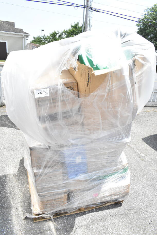 Plastic-wrapped pallet with assorted scratch and dent items, including platters, wine glasses, and containers, some packaging visible.