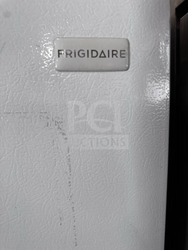 Frigidaire freezer, FFU21F5HWY model, 33" wide, 20 cu. ft., upright, shows logo on textured surface. Fully tested.