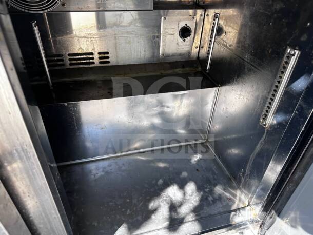 Turbo Air TWR-48SD-N two-door worktop refrigerator interior showing stainless steel condition, shelving tracks, and fan vent.