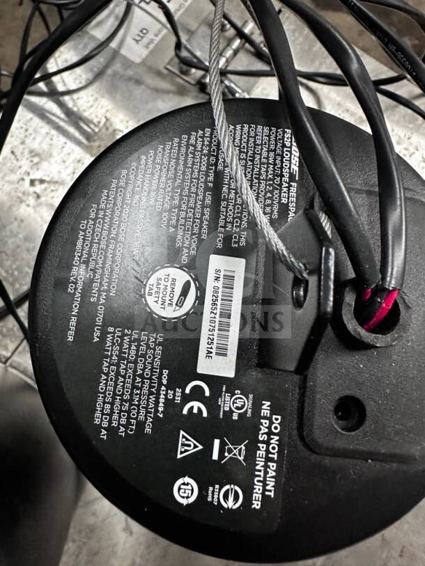 Black Bose FreeSpace FS2P pendant speaker with labels indicating model, safety certifications, and operational details.
