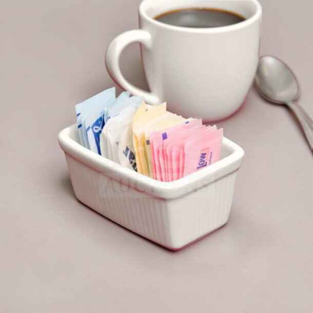 Tuxton BEQ-0452 sugar packet holder in eggshell china. New condition, ideal for commercial use. Holds 36 packets, model TUX-S-CAD-1148.