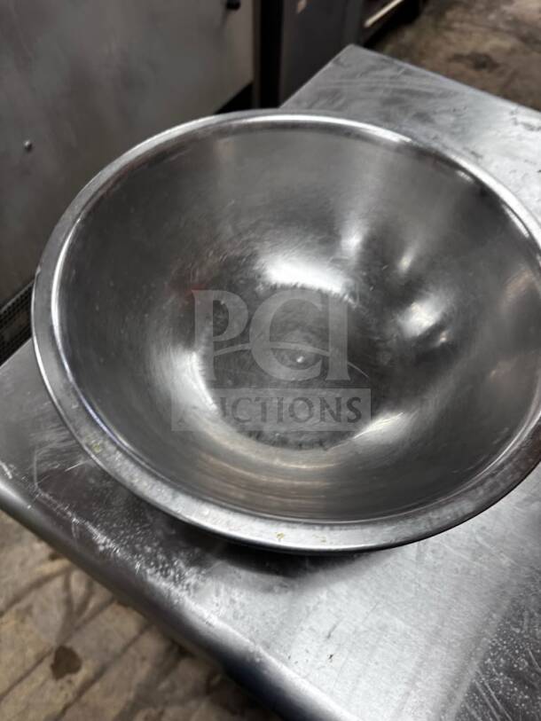 Stainless steel commercial salad/mixing bowl, 13" diameter, well-maintained, ready for commercial use.
