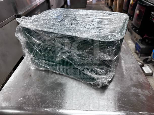 Stack of 25 Cambro 1216414 teal fiberglass trays wrapped in plastic, 12"x16", NSF certified, in superior condition.