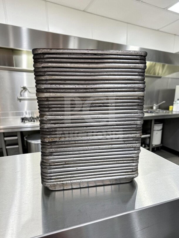 Stack of forty 1/4 size aluminum sheet pans, 18 gauge, by Commercial Kitchen Smallwares, in dependable condition.