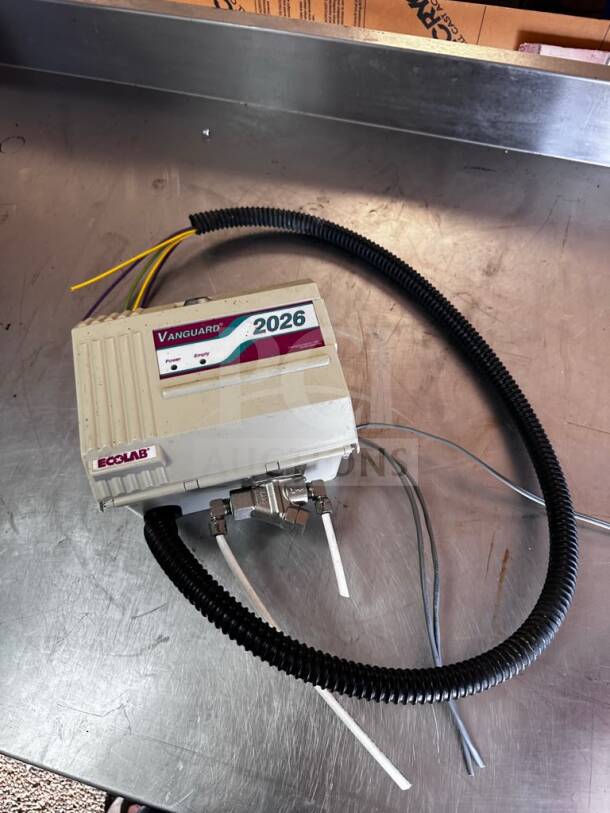 Ecolab Vanguard 2026 commercial detergent dispenser, UL listed, fully tested, operational; wires and labels visible.