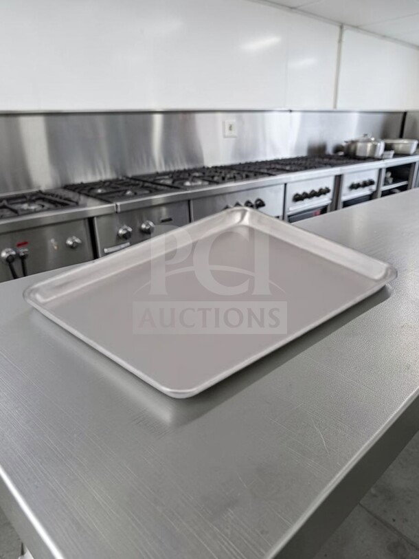 Commercial half-size aluminum sheet pan, model ALU-S-PAN-1173, by Commercial Kitchen Smallwares, in dependable condition.