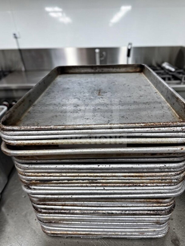 Stack of 30 Commercial Kitchen Smallwares 1/2 Size Aluminum Sheet Pans, used condition, ready for commercial use.