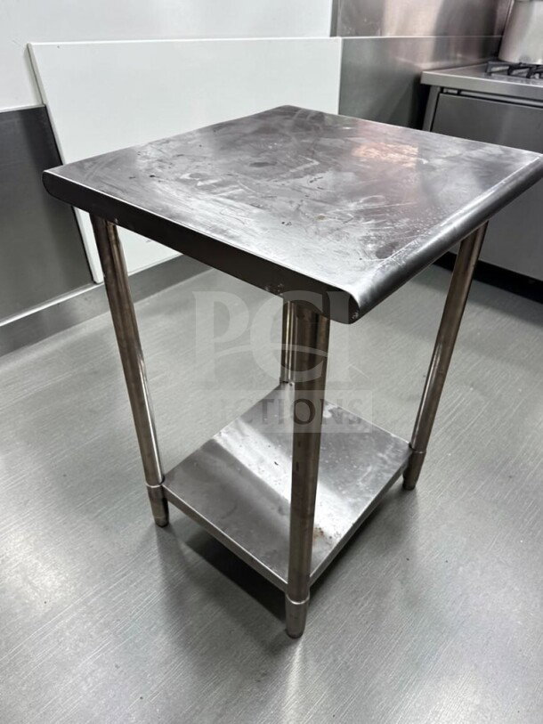 Stainless steel 24"x24" commercial work table in immaculate condition, ideal for prep work, features lower shelf.