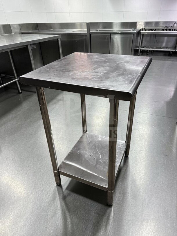 All stainless steel 24"x24" commercial work table in immaculate condition, ideal for kitchen use, with lower shelf for storage.