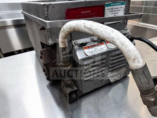 Commercial mobile fryer oil filtration system in excellent condition, labels warning about hot oil parts, fully operational.