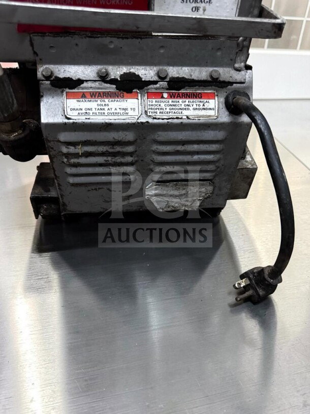 Commercial Mobile Fryer Oil Filtration System, excellent condition, warning labels visible, operational with power cord.