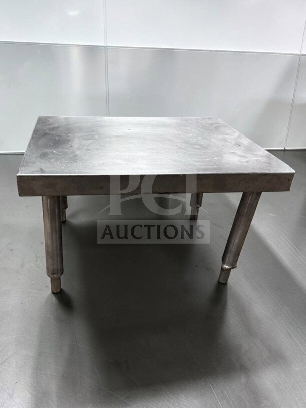 Heavy duty stainless steel commercial equipment stand, 24”x18”x15”, top-tier condition, ideal for commercial use.