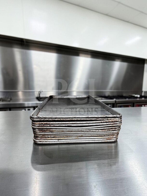 Stack of 13 full-size aluminum sheet pans, Commercial Kitchen Smallwares, model ALU-S-PAN-1178, well-maintained condition.