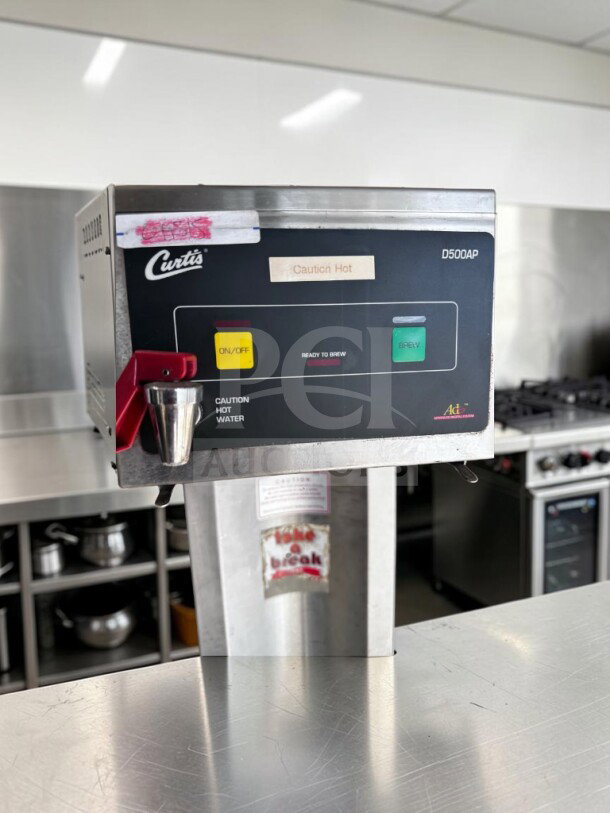 Wilbur Curtis D500-APT-12 commercial airpot coffee brewer, 120V, stainless steel, tested, operational, "Caution Hot" label visible.