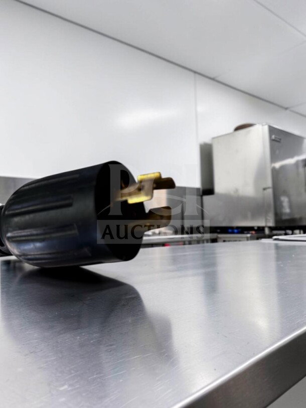 Commercial-grade BUNN ITCB-DV 29" Tea & Coffee Brewer on a stainless steel table, partially shown plug in foreground.