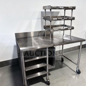 Pristine condition 60" x 34" custom stainless steel work table with over shelf, under table racks, and casters. Model GEN-S-TBL-1189.