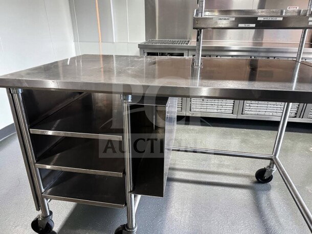 Pristine commercial stainless steel work table, 60"x34", with over shelf, under table racks, and casters. Model: GEN-S-TBL-1189.