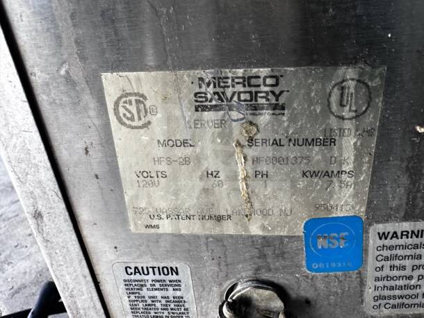 Metal label on Merco Savory HFS-2B commercial food warmer, showing model info, 120V, NSF/UL listings, and caution details.