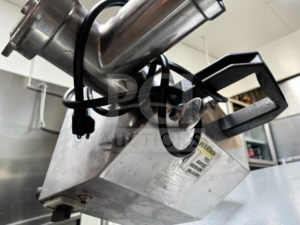 Globe Chefmate CC12 meat grinder in excellent condition, stainless steel finish, power cord visible, warning label attached.