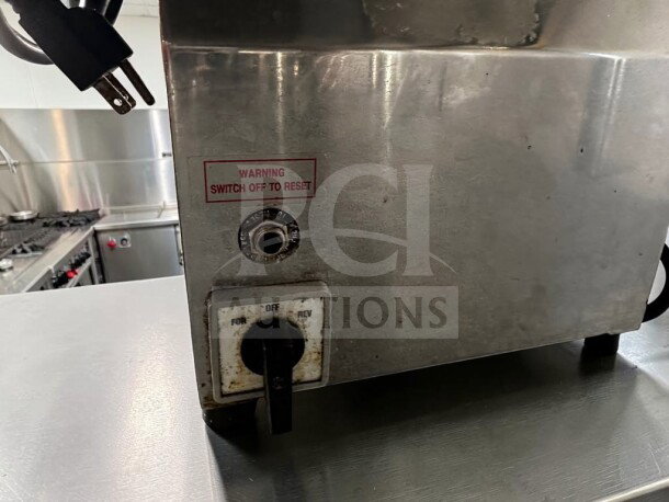 Globe Chefmate CC12 commercial meat grinder, 1 HP, #12 head, in outstanding condition, 250 lb/hr, power switch labeled.