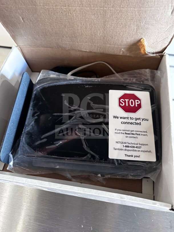 Brand new Netgear DGND3700-100NAS N600 Wireless Dual Band Gigabit ADSL2+ Modem Router in box with packaging and setup warning label.