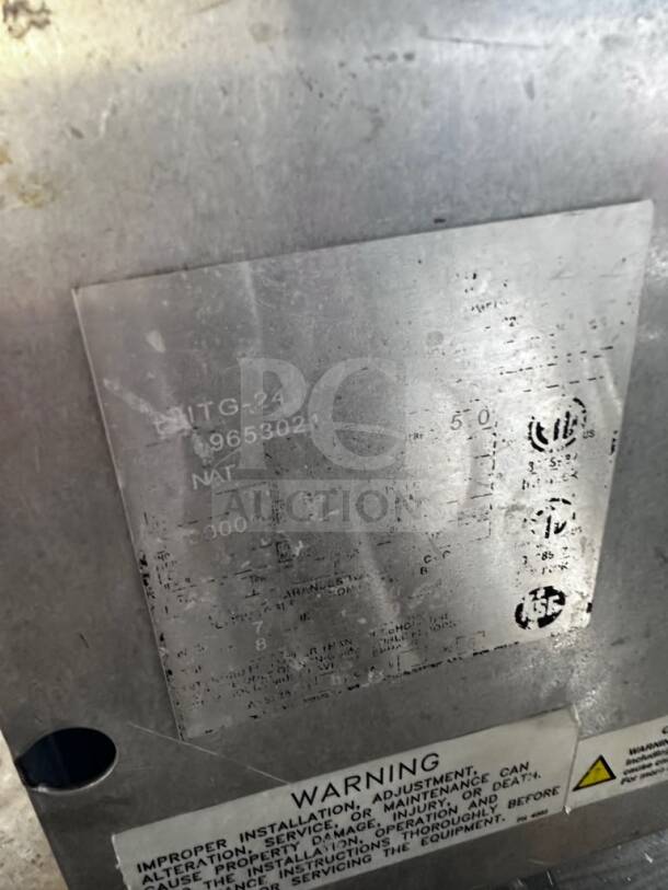 Metal plate with markings for Imperial Range ITG-24 gas griddle. Shows serial number, natural gas calibration, and warning label.