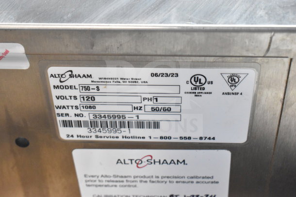Alt text: Alto Shaam 750-S holding cabinet label showing model, volts, watts, serial number, UL listing, and contact info.