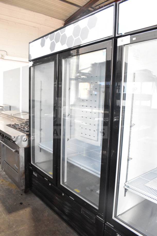 "Brand new Migali C-49FM-HCe commercial 2-door freezer merchandiser on casters, model C-49FM-HCe003220809092C0029."