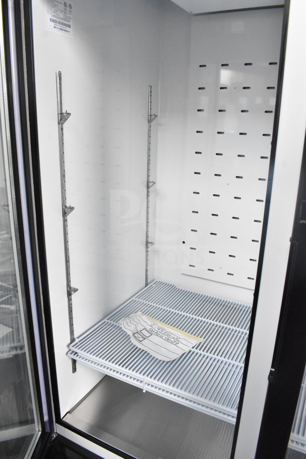 Brand new Migali C-49FM-HCe 2-door freezer merchandiser, scratch and dent, with commercial casters, 115V, 1 phase, interior view.