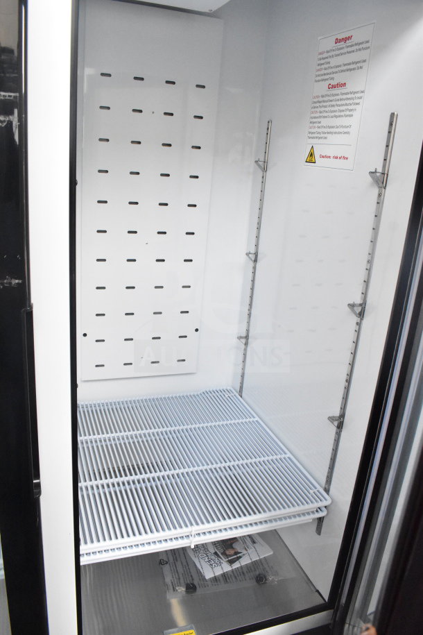 Brand new Migali C-49FM-HCe commercial two-door reach-in freezer merchandiser, white interior, commercial casters.