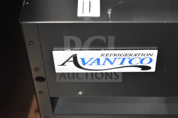 Avantco 178GDC12FHCB merchandiser freezer, black, swing glass door, LED lighting, on casters. Visible branding and minor scratches.