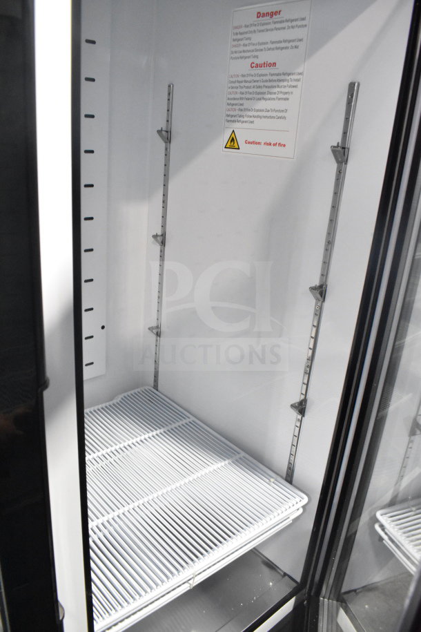 Brand new 2022 Migali C-49FM-HCe commercial 3-door freezer, scratch and dent, 115V, on commercial casters. Serial visible.
