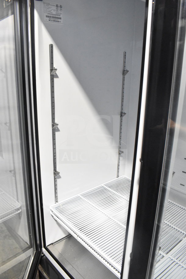Migali C-49FM-HCe commercial 3-door freezer, brand new with minor scratches, features interior shelving and labels.