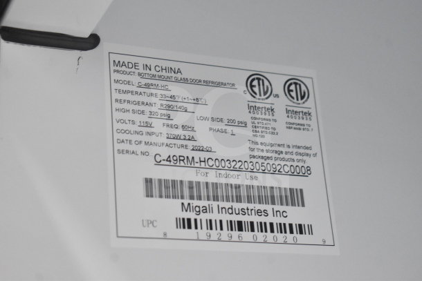 Label on Migali C-49RM-HC cooler showing model info, voltage, refrigerant type, manufacturing date, and serial number.