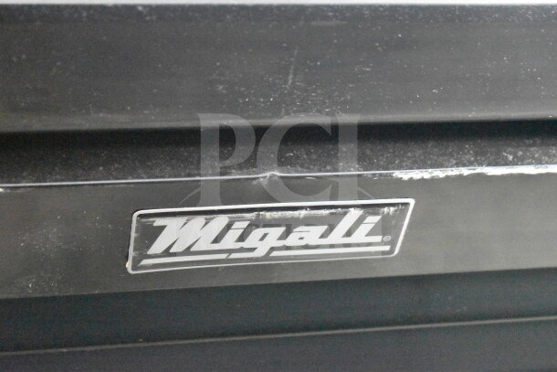 Migali logo on 2019 Migali C-49FM-HC commercial reach-in freezer, brand new with scratch and dent, seen on black surface.