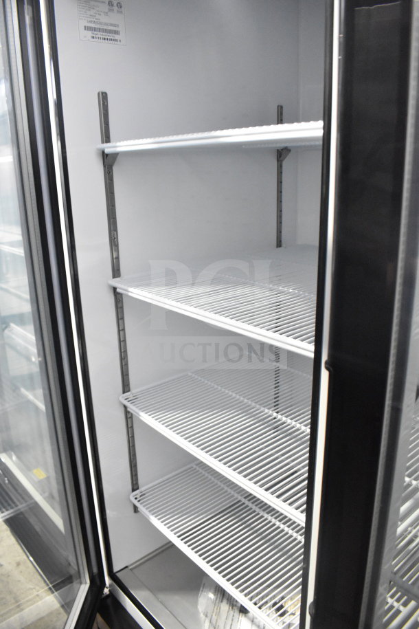 Brand new Migali C-49FM-HC 3-door reach-in freezer with shelving, on commercial casters. 115V, 1 Phase. Serial visible.