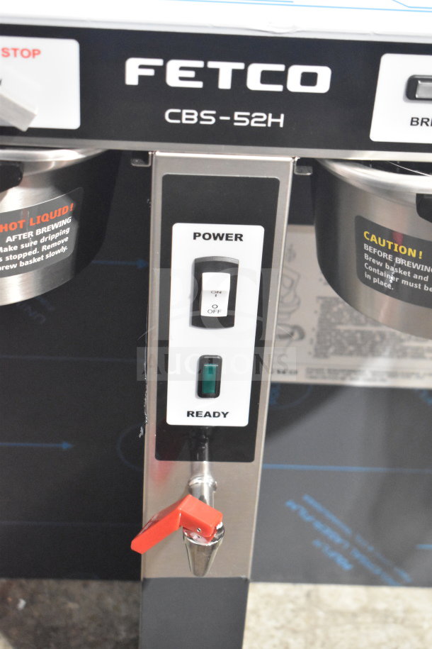 Alt text: "Fetco CBS-52H15 commercial coffee brewer, brand new scratch and dent, with power controls and caution labels visible."