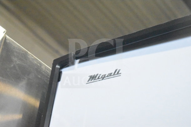 Brand new Migali C-72FM-HC 3-door cooler, 115V, 1 Phase, on casters. Logo visible, some scratches present. Serial: C-72FM-HC003220304092C0007.