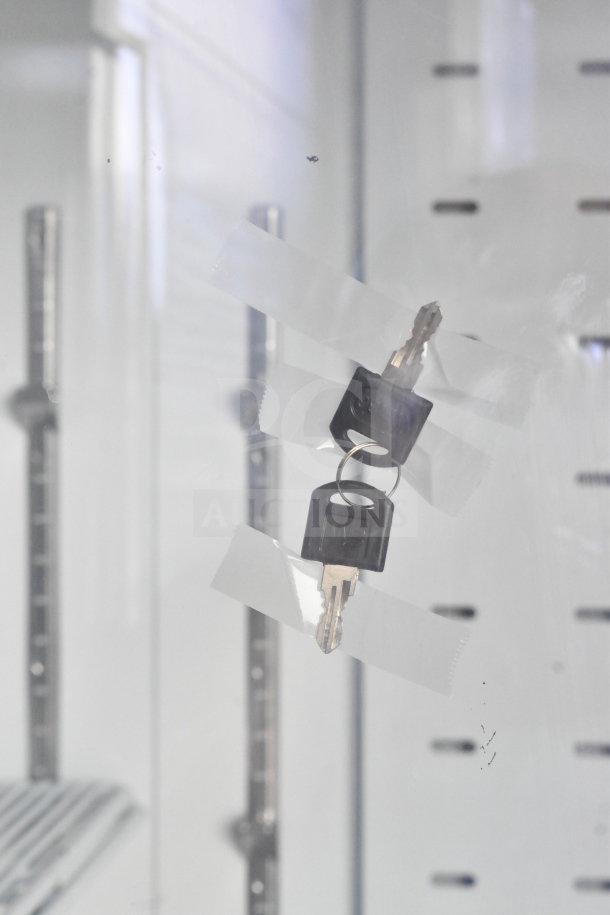 Migali C-49FM-HC freezer interior with taped keys on door, showcasing adjustability and shelving inside.