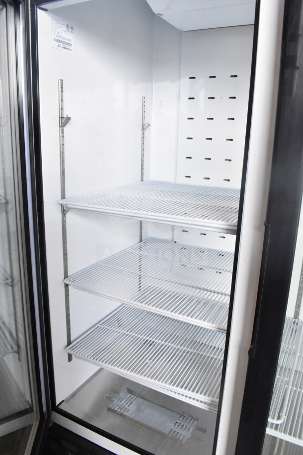 Brand new 2019 Migali C-49FM-HCe commercial reach-in freezer, two glass doors, on casters. Some scratches and dents visible.