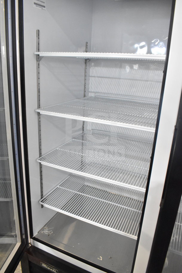 Migali C-49RM 2-door reach-in freezer merchandiser on casters, shelves visible, 115V, new with minor dents.