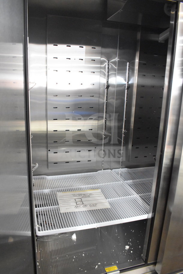 Brand new 2023 Migali C-3FB-HC commercial 3-door reach-in freezer with shelves, scratch and dent, on casters.