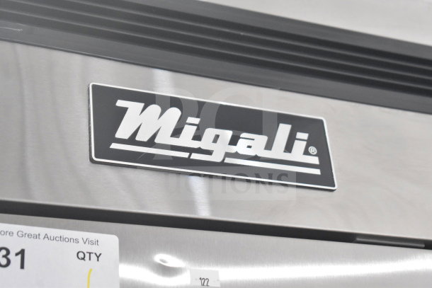 Migali C-3FB-HC commercial freezer logo on stainless surface, auction tag visible.