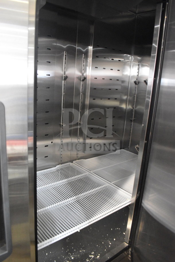 Brand new Migali C-3FB-HC commercial 3-door freezer, scratch and dent, on casters, 115V, 1 phase, interior view.