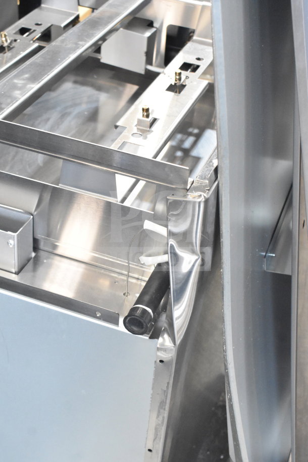 Brand new Migali C-RO8B-NG commercial 8 burner range with 2 ovens, showing minor dents on stainless steel exterior.