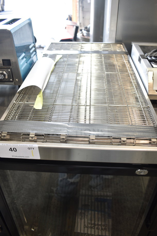 BRAND NEW Cooking Performance Group 35132BELT 32" conveyor belt. Scratch and dent condition. Auction tag visible.