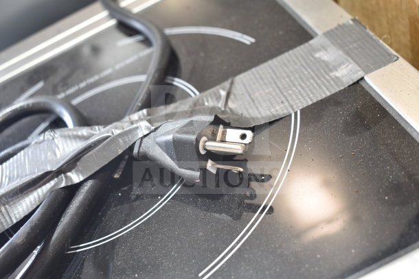 Brand new Avantco 177IC3500 induction range, 208-240V, minor scratches, duct tape on power cord, sleek black surface.